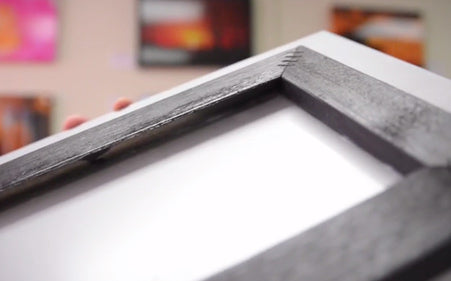Back view of a fine art print showing the recessed black mounting system for ready-to-hang wall display.