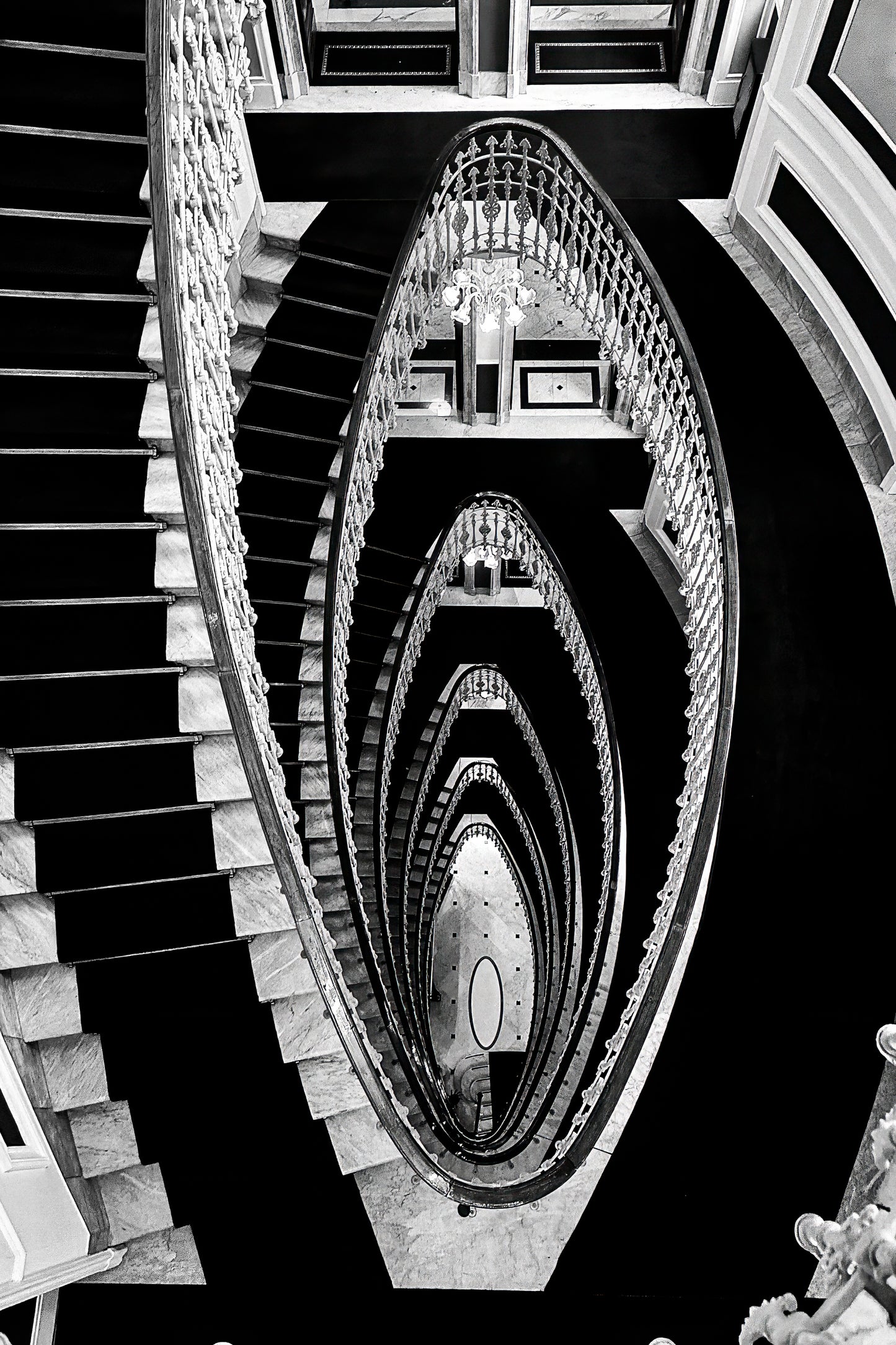 Dramatic staircase inside Hotel Bristol Palace in Genoa, Italy, with sweeping architectural lines and historic interior detail.