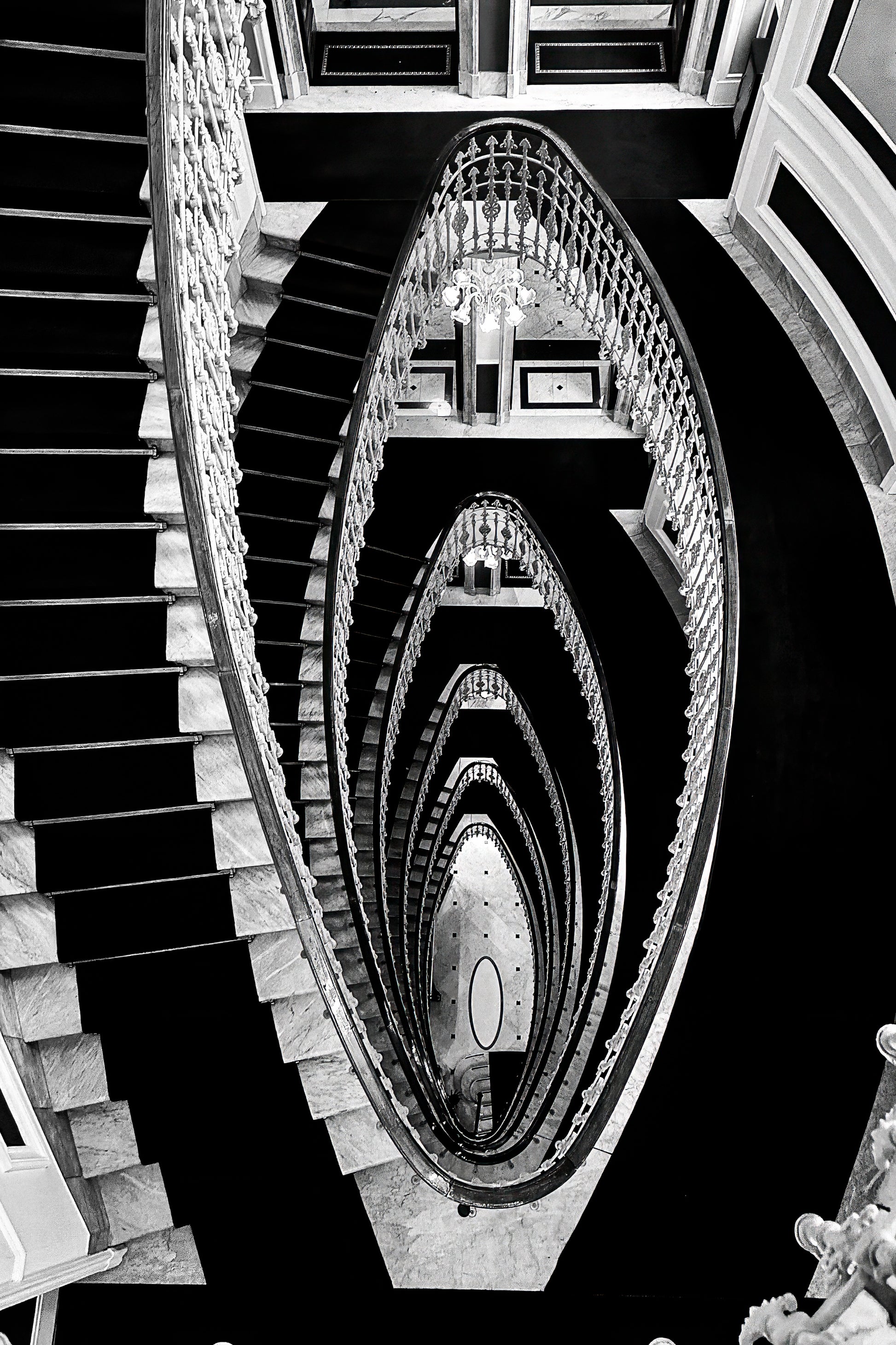 Dramatic staircase inside Hotel Bristol Palace in Genoa, Italy, with sweeping architectural lines and historic interior detail.